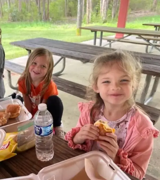 Children enjoying lunch from Laila’s Place at a picnic table in Newberry, SC